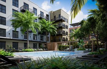 an outdoor pool with palm trees in front of an apartment building