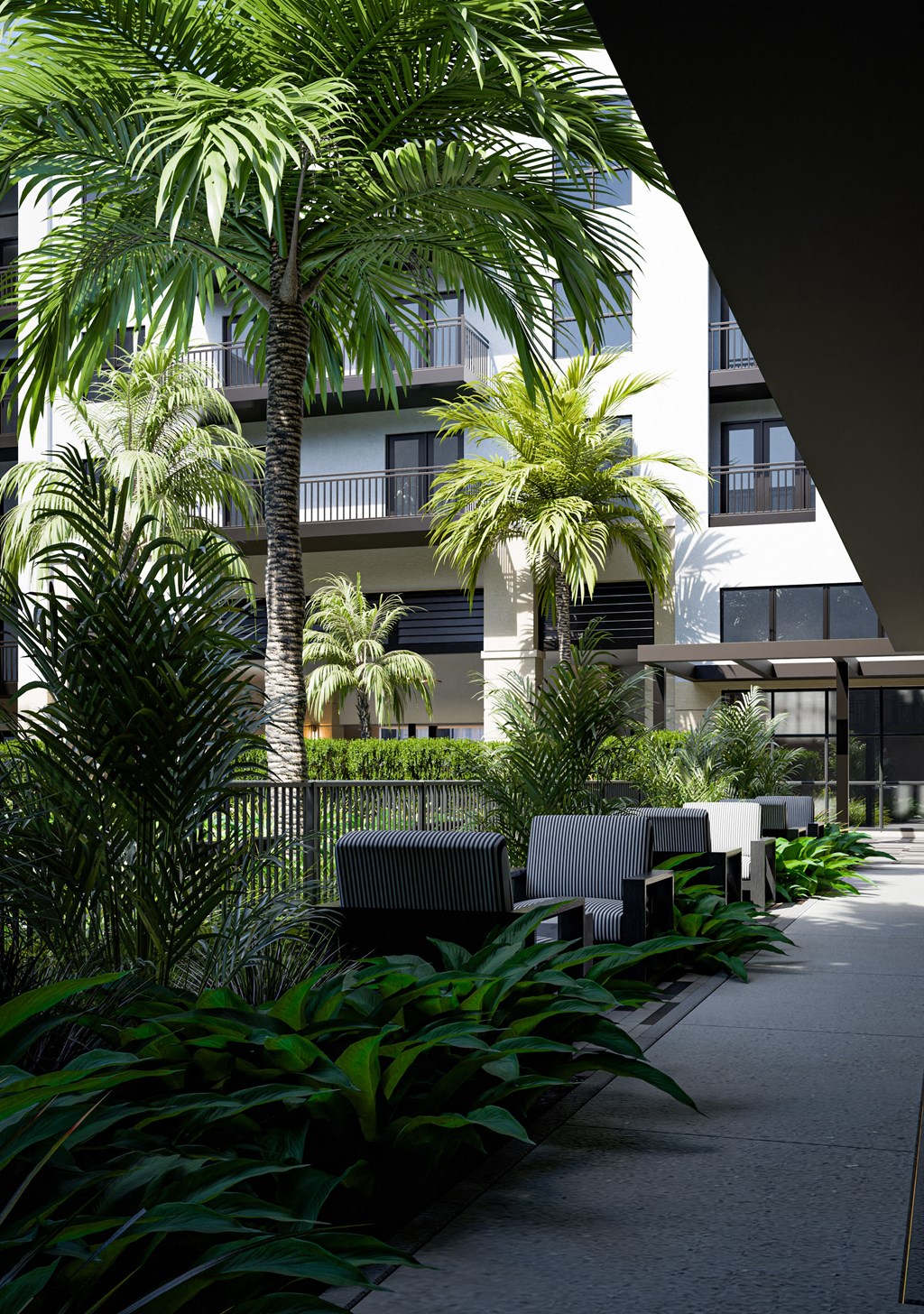 a courtyard with benches and palm trees in front of a building
