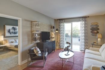 a living room with a couch and a table and a television at Fort Totten Square, Washington DC