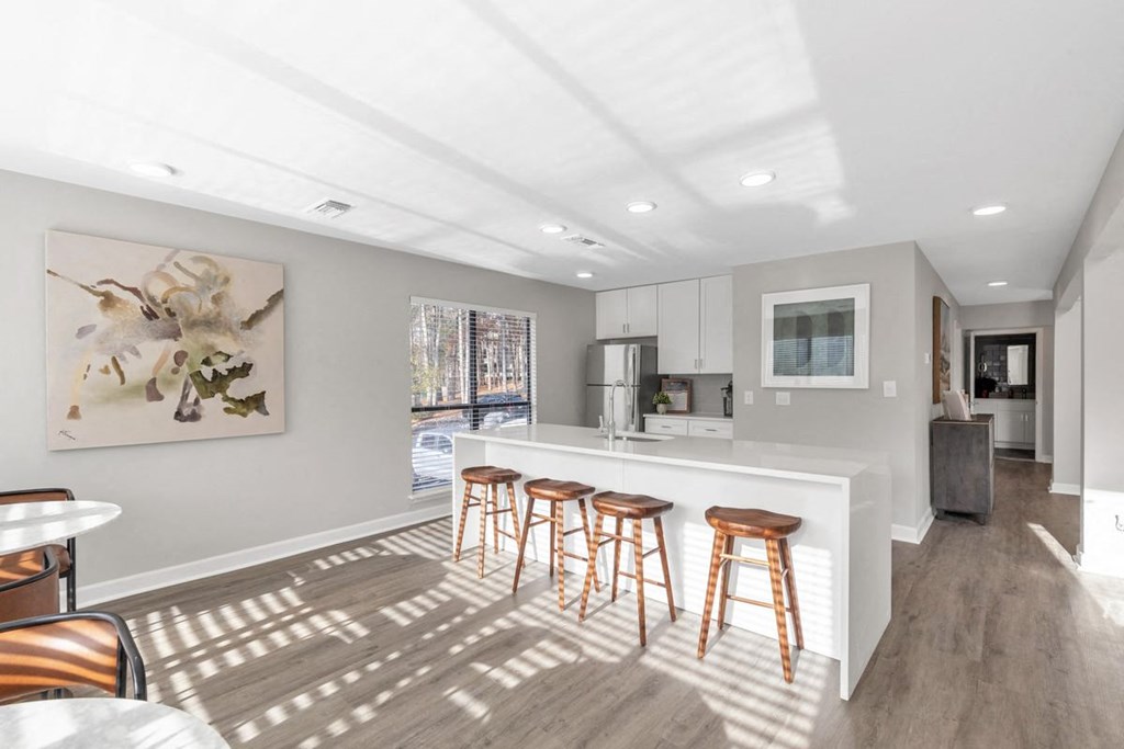a kitchen with a bar and stools  at Brampton Moors, Cary, NC