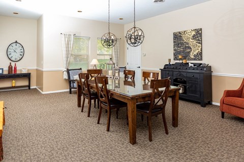 A dining room with a wooden table and chairs.