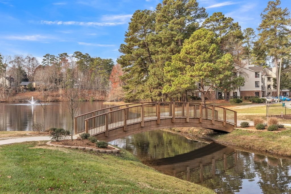 a bridge over a pond with a house in the background  at Brampton Moors, North Carolina, 27513