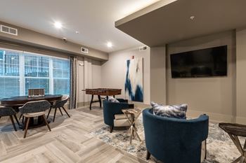 A Living Room With Wooden Table at The Aster Apartments, Cary, NC