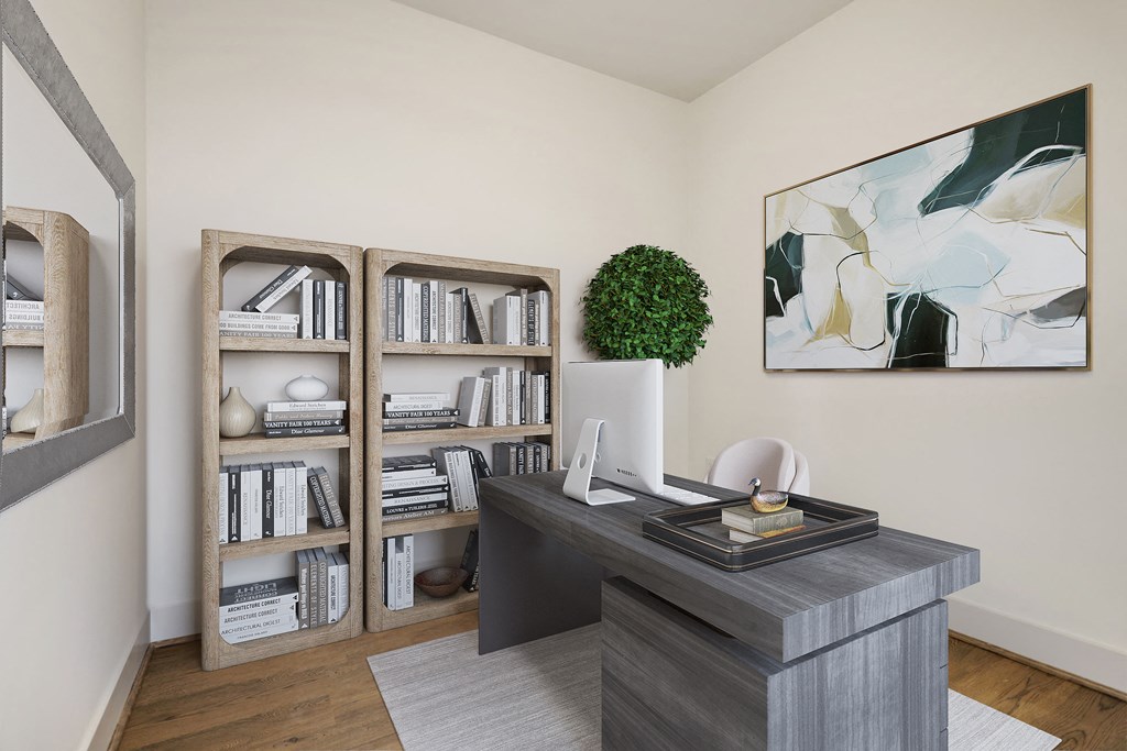 a home office with a desk and a bookshelf