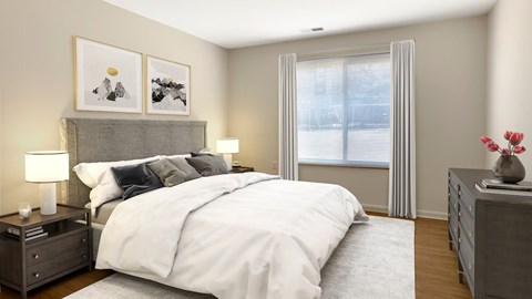 A bedroom with a large bed, a nightstand with a lamp, and a dresser with a vase of flowers.