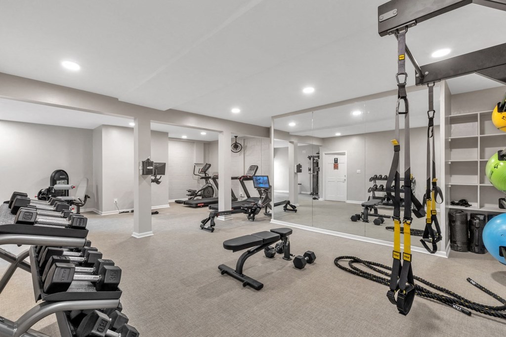 a gym with weights and cardio equipment in a room with white walls  at Brampton Moors, North Carolina