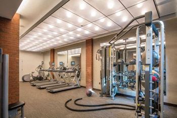 a gym with a lot of machines and weights