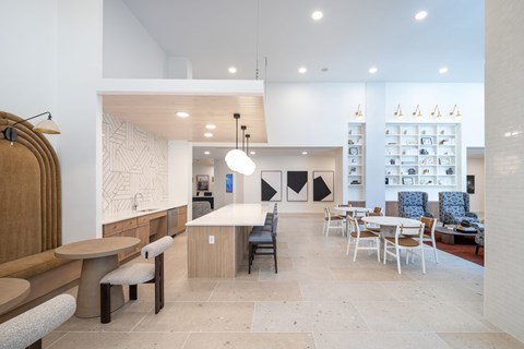 A modern dining area with a white and wood theme at The Sully Apartments, Chantilly, Virginia