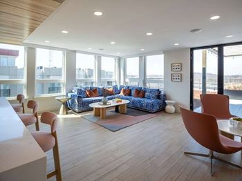 A living room with a blue sofa and wooden floors at Jayde Parkside Apartments, Washington DC, 20019