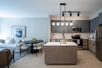 A modern kitchen with a dining table and chairs at Jayde Parkside Apartments, Washington