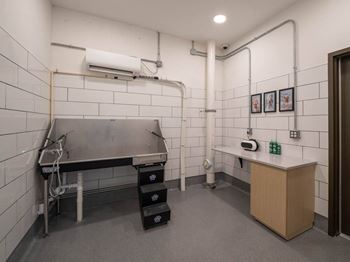 A kitchen with a stainless steel table and a white tile wall at Jayde Parkside Apartments, Washington, Washington DC