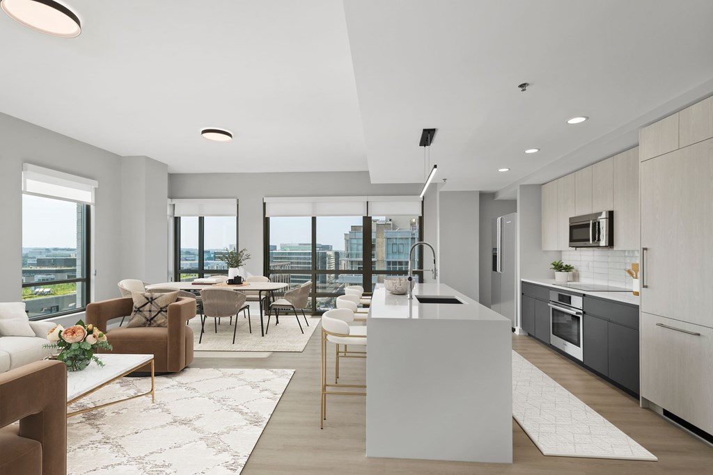 A modern kitchen and dining area with a view of the city.