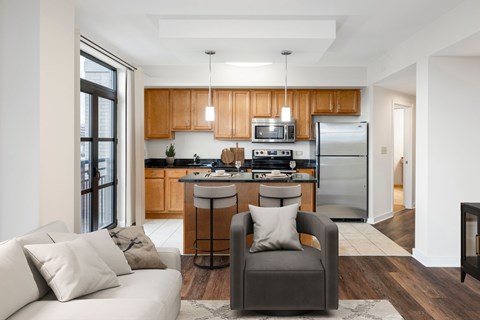 A modern kitchen with wooden cabinets and a refrigerator.