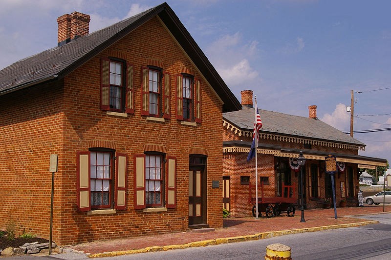 a red brick building on the side of a street