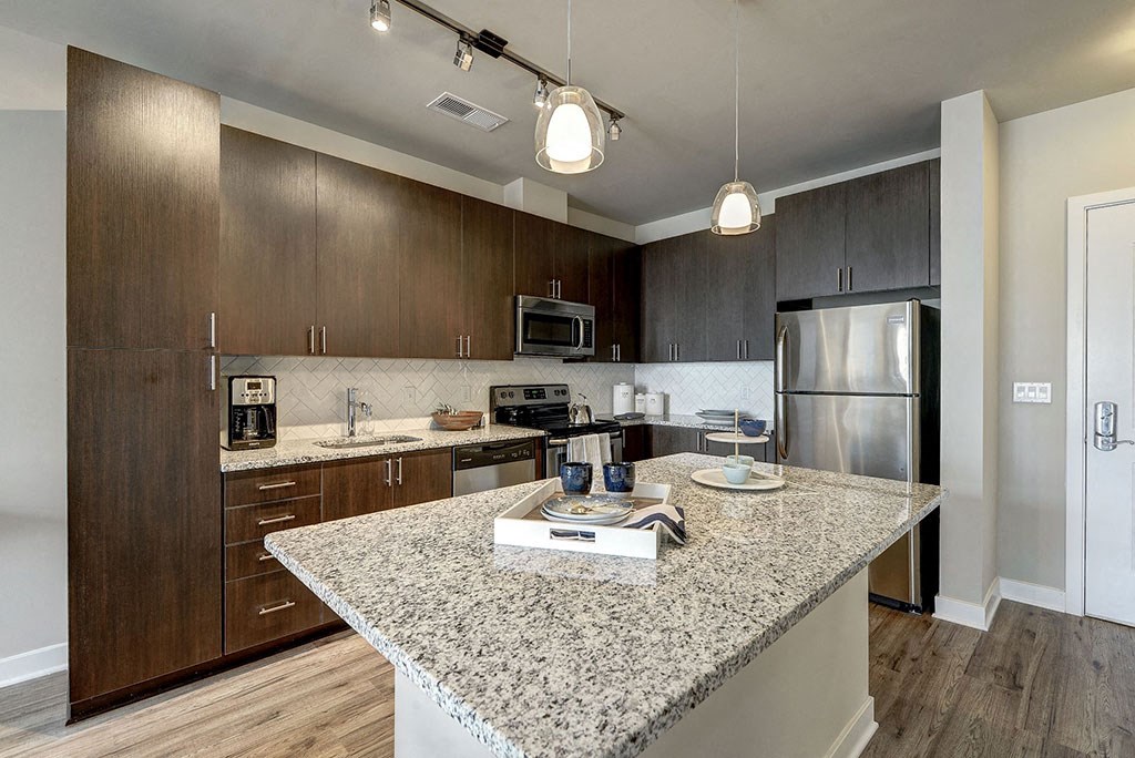 Kitchen with an island and stainless steel appliances at Highgate At The Mile in McLean 22102