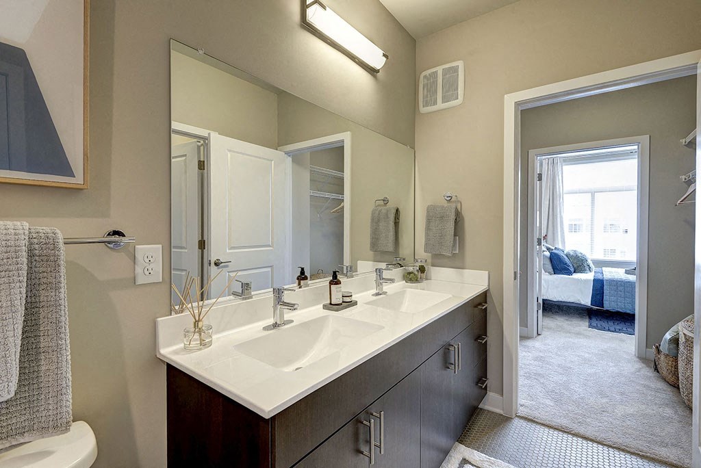 Bathroom with a large mirror and two sinks at Highgate at Highgate at the Mile, McLean, VA