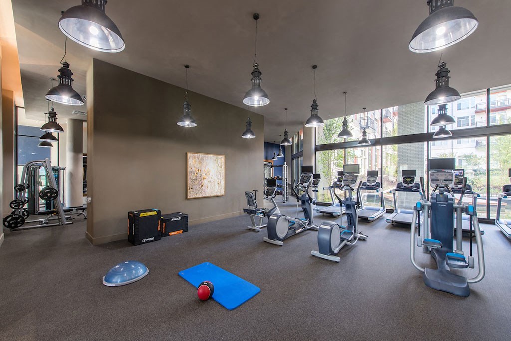 Fitness center with treadmills and other exercise equipment at Highgate at Highgate at the Mile, Virginia