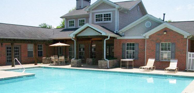 a large swimming pool in front of a house