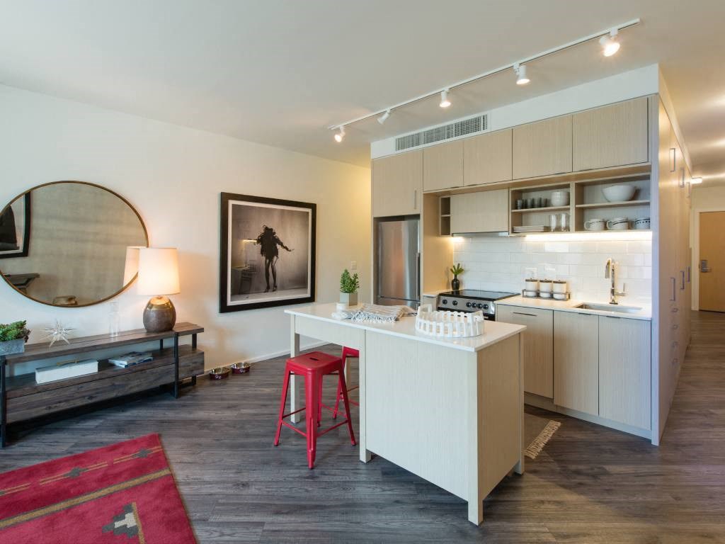a kitchen and living room with a white counter