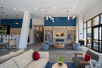 A modern living room with a fireplace and a large window at Jayde Parkside Apartments, Washington 20019