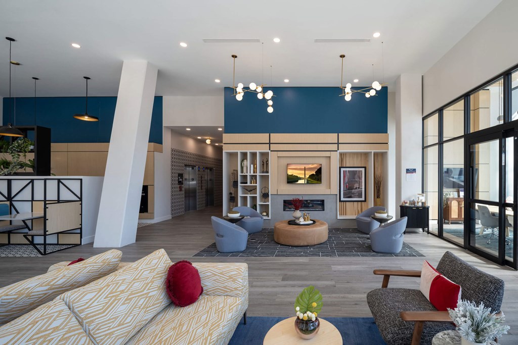 A modern living room with a fireplace and a large window at Jayde Parkside Apartments, Washington DC, 20019