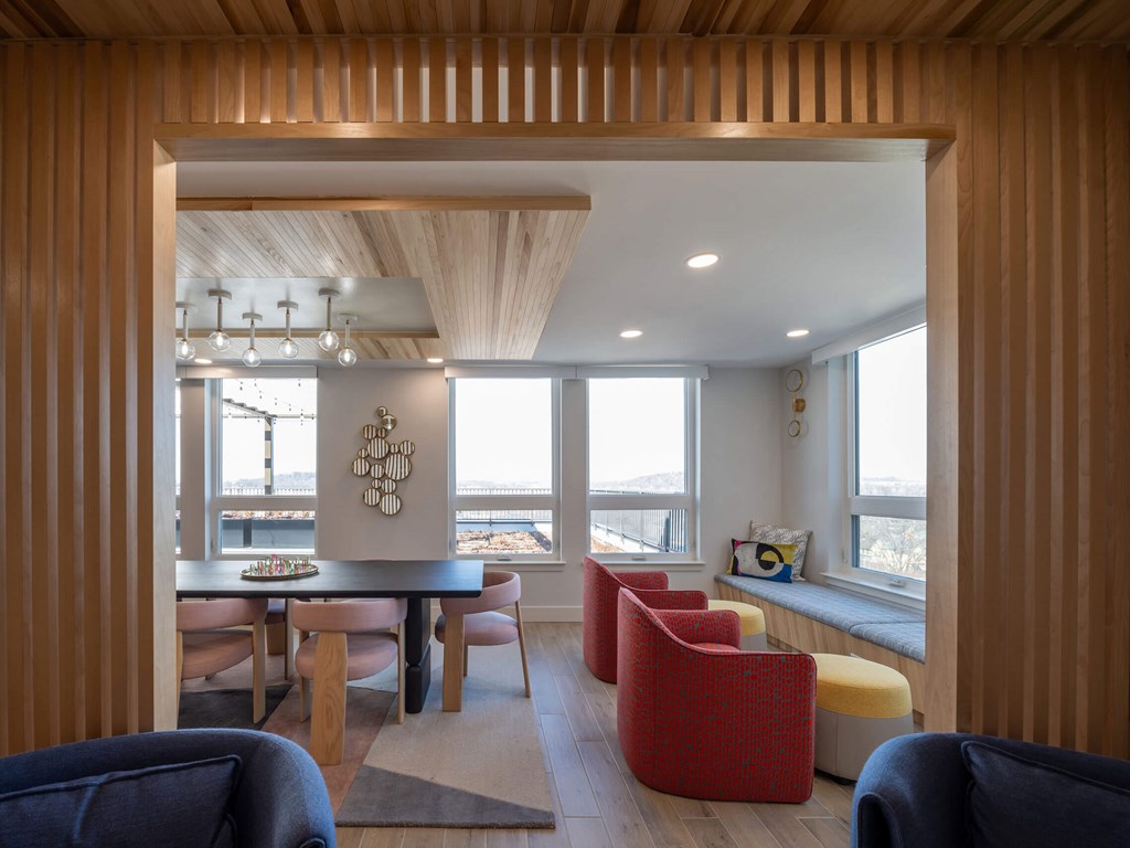 A modern living room with a dining table and chairs at Jayde Parkside Apartments, Washington, DC