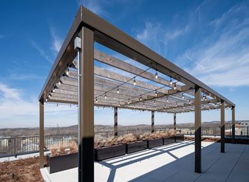 A modern pergola with wooden slats and metal frame at Jayde Parkside Apartments, Washington, DC, 20019