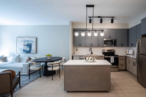 A modern kitchen with a dining table and chairs.
