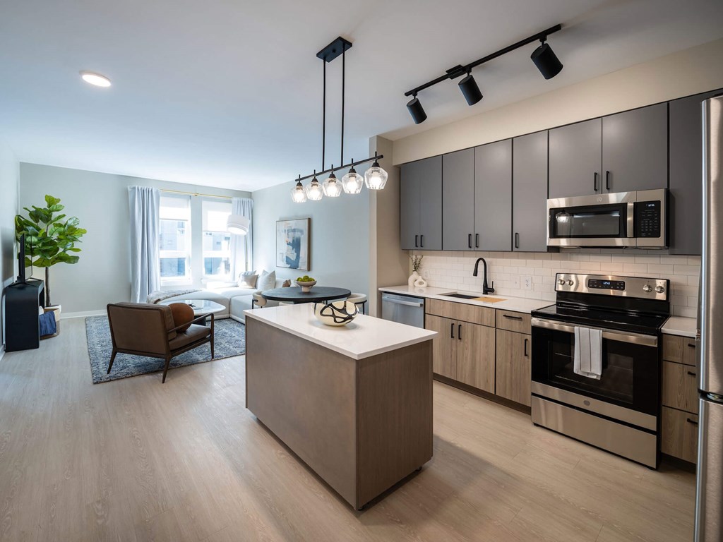 A modern kitchen with a wooden island and stainless steel appliances at Jayde Parkside Apartments, Washington, Washington DC