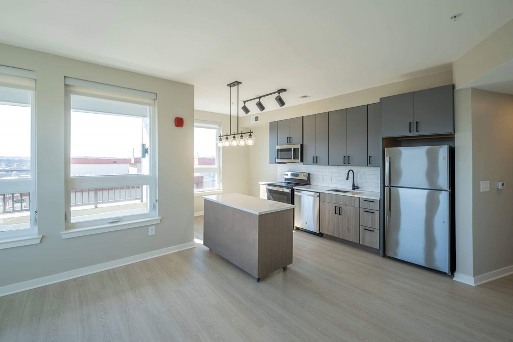 A kitchen with a refrigerator, sink, and cabinets at Jayde Parkside Apartments, Washington, Washington DC