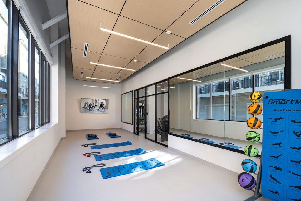 A yoga studio with blue mats and a sign at Jayde Parkside Apartments, Washington 20019