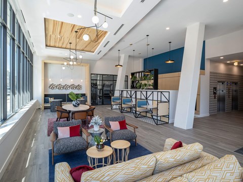 A modern living room with a large couch and a dining table.