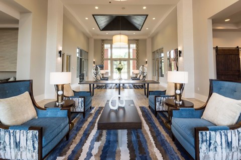 A living room with blue couches and a coffee table.