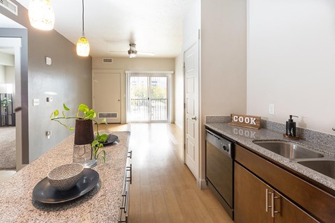 A kitchen with a counter top and a sink.