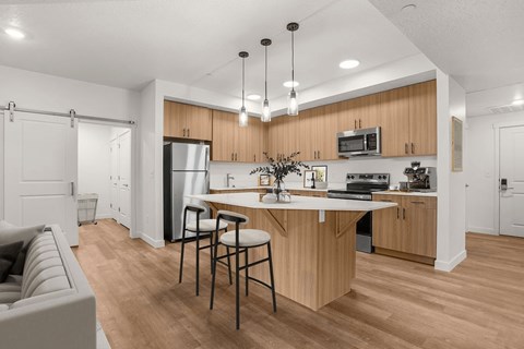 A modern kitchen with wooden cabinets and a white island.