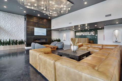 A living room with a large sofa and a coffee table.