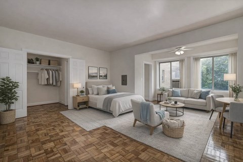 A bedroom with a large bed, a couch, and a chair in the foreground.