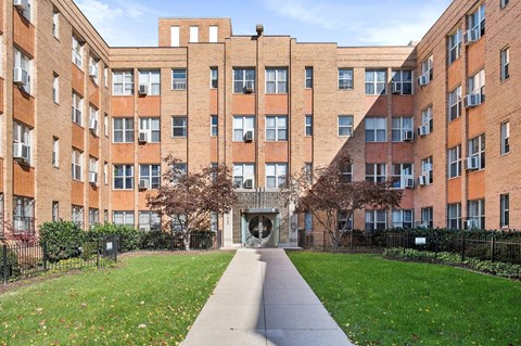 Brick apartment building with courtyard entrance at Tivoli Gardens Apartments, Washington