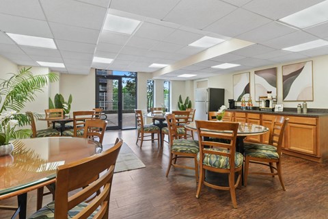A kitchen with wooden chairs and tables.