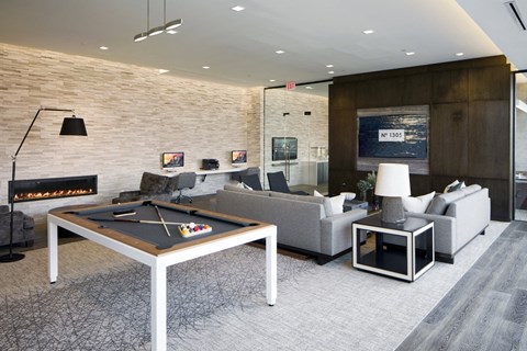 A billiard table is in the middle of a living room.