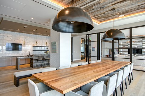 Modern dining room with wood table and pendant lighting at 1405 Point Apartments, Baltimore, 21231