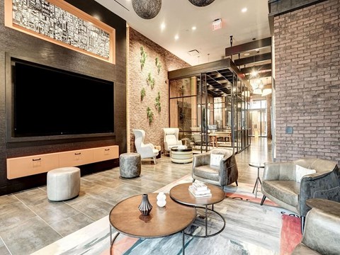 A modern living room with a flat screen TV and comfortable seating.
