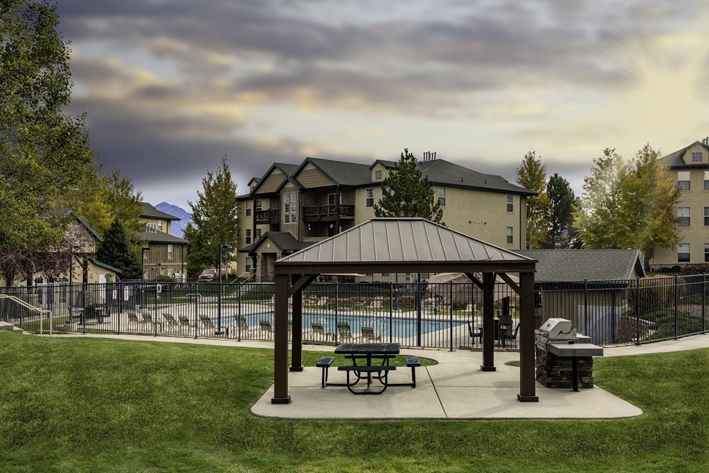 A covered picnic area with a pool in the background.at Sunset Ridge, West Jordan Utah