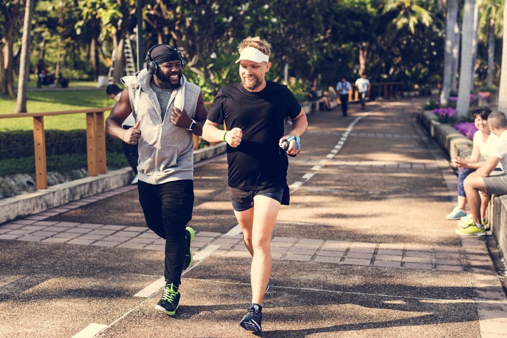 two men running down a street during a race