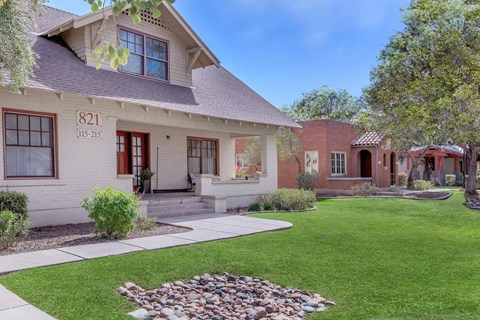 A house numbered 821 with a red door and a small garden in front at Roosevelt Commons Apartments, Phoenix, AZ, 85003
