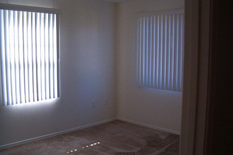 A room with a window on the left and a window on the right at Roosevelt Commons Apartments, Phoenix, AZ