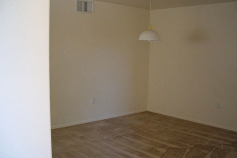 A room with a light hanging from the ceiling at Roosevelt Commons Apartments, Phoenix, AZ, 85003