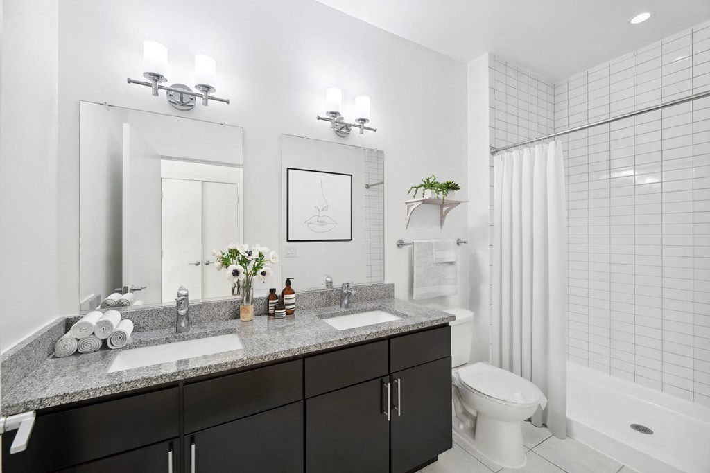 a bathroom with two sinks and a shower and a toilet at Fort Totten Square, Washington, 20011