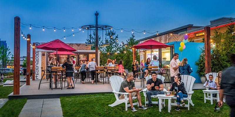 a group of people sitting and standing around a patio at Vyne One Loudoun, Ashburn, Virginia