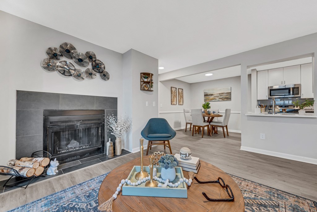 a living room with a fireplace and a dining room in the background at Brampton Moors, Cary